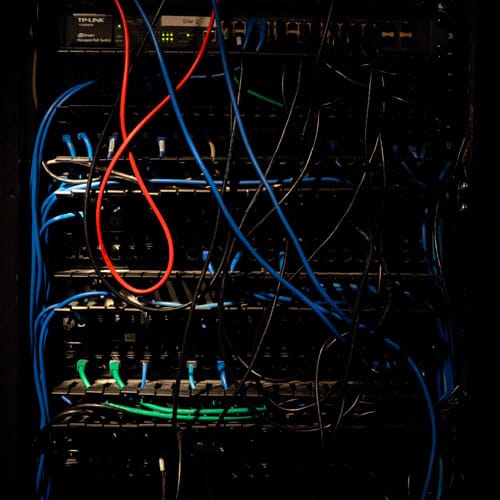 image of it infrastructure - many wires hanging from the back of a metal box